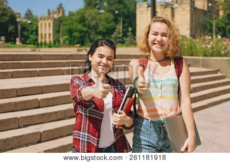Joyful Girls Show Thumbs Up. Best Frinds Have A Good Time And Show That Everyhing Is Ok
