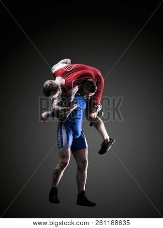 Two Wrestlers Figting Isolated On Black Back