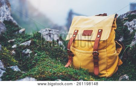 Hipster Hiker Tourist Yellow Backpack On Background Green Grass Nature In Mountain, Blurred Panorami