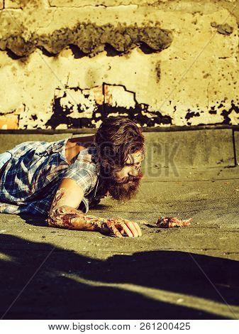 Bearded Zombie Man With Beard Creepy Vampire Or Bloody War Soldier With Wounds And Red Blood Lies On