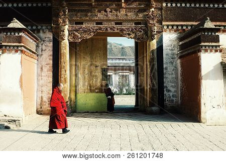Labrang Monastery, Xiahe, Gansu Province / China - Jun 6 2011: A Tibetan Monk Walking Past By One Of