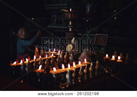 Labrang Monastery, Xiahe, Gansu Province / China - Jun 6 2011: Young Pilgrim Girl Making A Donation 