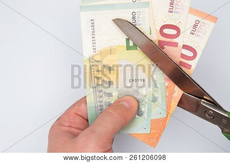 Euro Money Being Cut In Two With Scissors Isolated On White Background