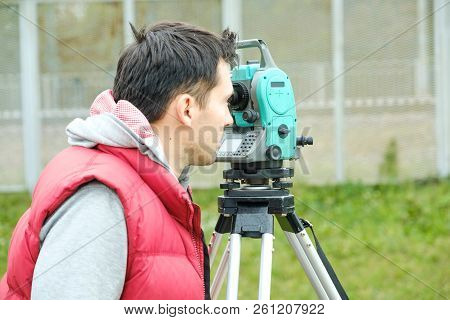 Civil Engineer Land Survey With Tacheometer Or Theodolite Equipment. Worker Checking Construction Si