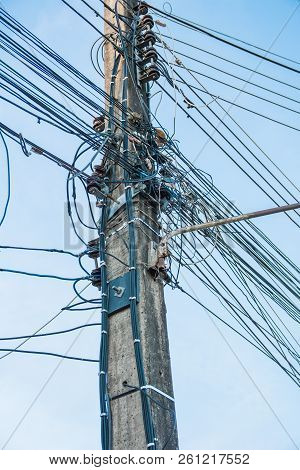 Wire Assemblage A Lot Of Cables And Wires On Pole In The City.