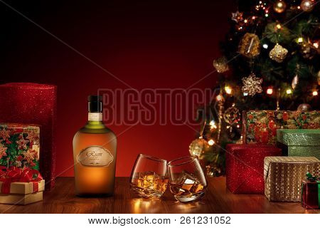 Close Up View  Of Bottle And Two Glasses With Rum On Color Back. Self Made Label.