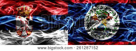 Serbia Vs Belize, Belizean Smoke Flags Placed Side By Side. Thick Colored Silky Smoke Flags Of Serbi