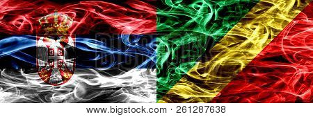 Serbia Vs Congo, Congolese Smoke Flags Placed Side By Side. Thick Colored Silky Smoke Flags Of Serbi