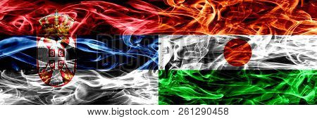 Serbia Vs Niger, Nigerian Smoke Flags Placed Side By Side. Thick Colored Silky Smoke Flags Of Serbia