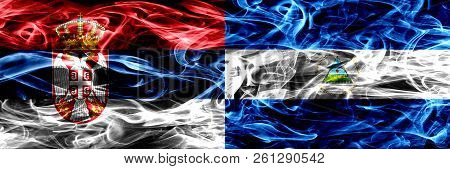 Serbia Vs Nicaragua, Nicaraguan Smoke Flags Placed Side By Side. Thick Colored Silky Smoke Flags Of 