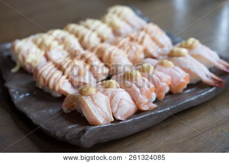 Set Of Salmon Aburi Sushi With Sauce On Plate