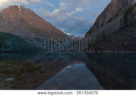 Reflection Of The Shore Of The Lake In The Watery Surface. The Large (lower) Shavlinsky Lake. Altai 