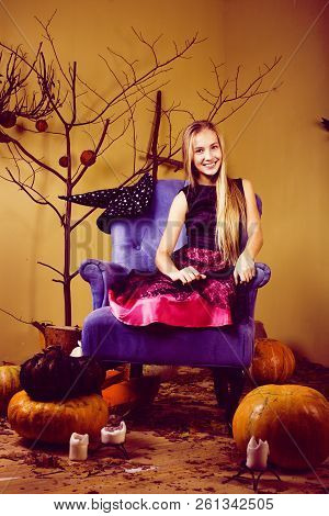 Young Pretty Teenage Girl In Halloween Holiday Decorated Interio