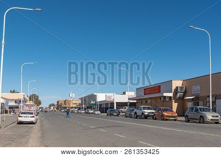 De Aar, South Africa, August 6, 2018: A Street Scene, With Businesses, People And Vehicles, In De Aa