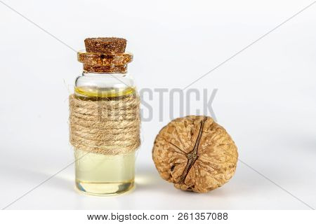 Oil In A Bottle And Walnuts On A White Kitchen Table. Spices And Ingredients Useful In Kuchi.