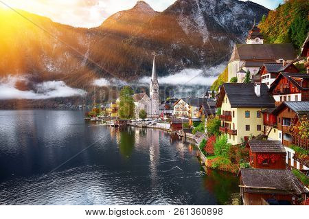 Scenic View Of Famous Hallstatt Mountain Village With Hallstatter Lake. Foggy Autumn Sunrise On Hall