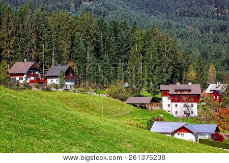 Alpine Green Fields And Traditional Wooden Houses View Of The Gosau Village At Autumn Sunny Day. Loc