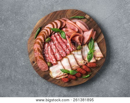 Antipasto Set Platter Wooden Plate On Gray Stone. Cold Smoked Meat Plate With Sausage, Sliced Ham, P