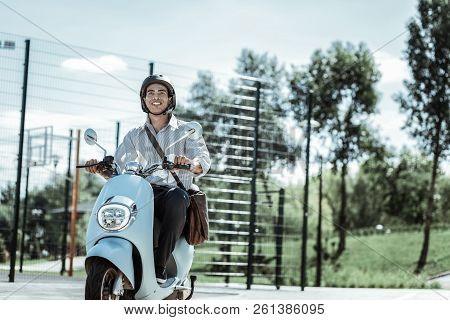 Jolly Male Student Having Ride On Motorbike
