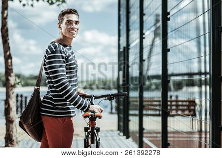 Positive Energetic Guy Choosing Bicycle For Riding