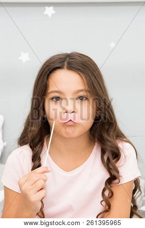 Slumber Party Photo Booth Props. Kid Girl Frowned Posing With Pink Mustache Party Attribute. Prepare