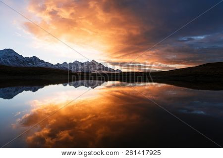 Koruldi - mountain lake in Svaneti, Georgia. Mirror reflection in water. Landscape with beautiful dawn