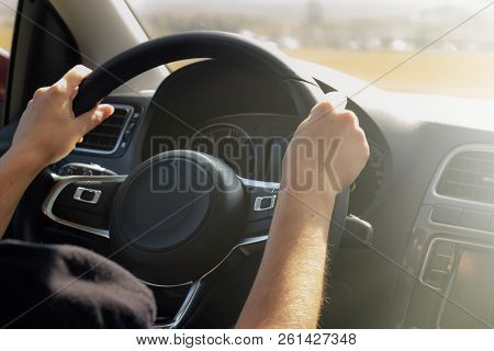 Women's Hands On The Steering Wheel Of The Car. Concept Woman Driving,feminism, Freedom And Independ
