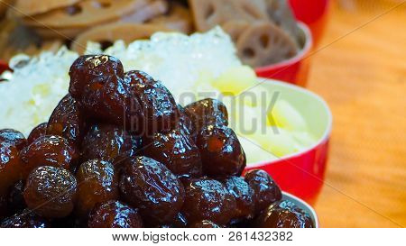 Sweet Chinese Red Date Recipes, Red Jujube Date On Blur Of Red Bowl Of Sliced Lotus Root And Crushed
