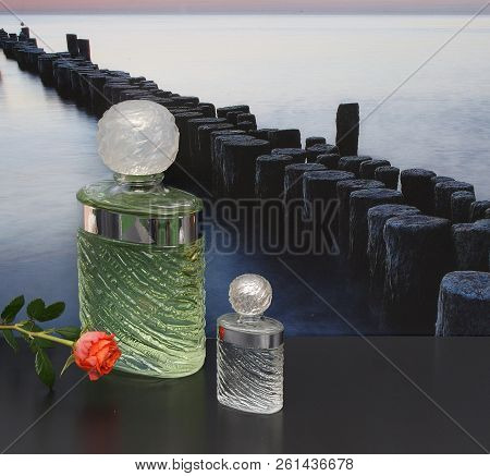 Fragrance For Ladies, Large Perfume Bottle Next To A Commercial Perfume Bottle In Front Of The Pictu