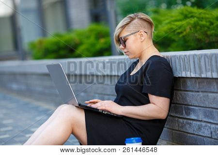 Woman Plus Size Walking Outdoors With Laptop In Sunglasses, Haircut Is Creative. Freelancer Works, L