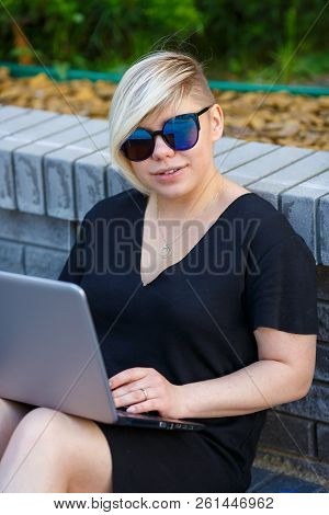 Woman Plus Size In Sunglasses Smiles On A Bright Sunny Day In The Street, A Haircut Is Creative, Ove