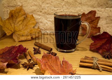 Red Mulled Wine With Spices: Cinnamon And Anise Stars, Autumn (fall) Leaves Background.