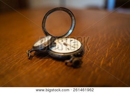 Two Old Pocket Watches Are On A Table