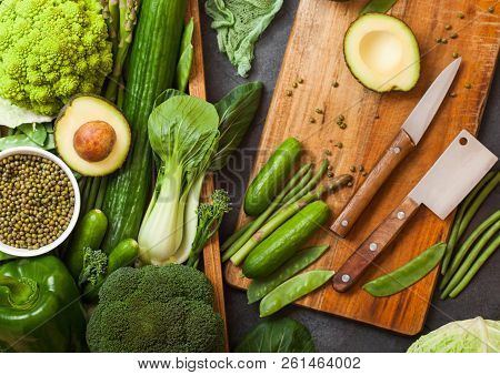 Assorted Green Toned Raw Organic Vegetables In Wooden Box On Dark Stone Background. Avocado, Cabbage