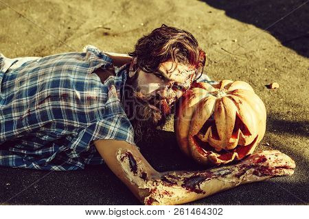Bearded Zombie Man With Beard Creepy Vampire Or Bloody War Soldier With Wounds And Red Blood Lies On