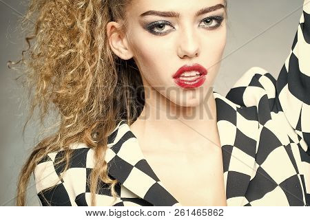 Portrait Of Attractive Radiant Looking Blond Young Woman With Fly-away Wavy Long Hair Wearing Black 