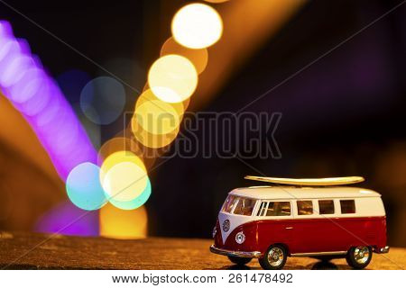 Gold Coast, Australia - August 11 2018: Minature Kombi With Surfboard On Top With Bokeh Citylights I