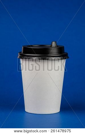 Paper Coffee Container With Black Lid On Blue Background. Take-away Beverage Container. Drink Cup Te