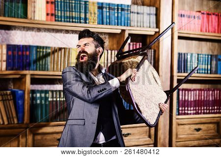 Man Throws A Chair In Vintage Librar