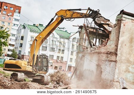 excavator crasher machine at demolition on construction site