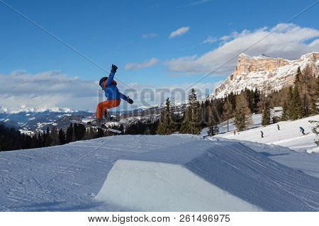 Skier In Action: Ski Jumping In The Mountain Snowpark.