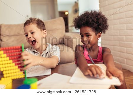 Multiracial Children Drawing Using Abacus At Home