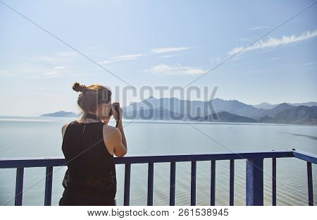 A Young Girl Photographs The Lake. Tourist Takes A Photo Of Skadar Lake. Skadar Lake. National Park.