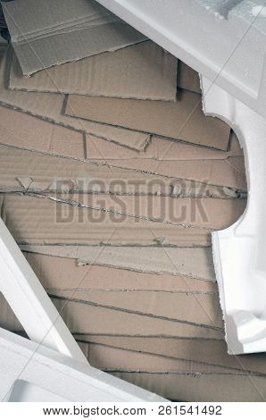 Background Image With A Lot Of Beige Cardboard Paper And Styrofoam Boxes Disgarded As Rubbish. The C