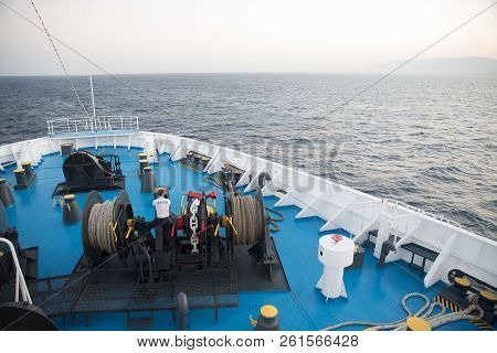 Aegean Sea, Greece/ July 17, 2018: Seaman Working On Foredeck Of Ferry Boat