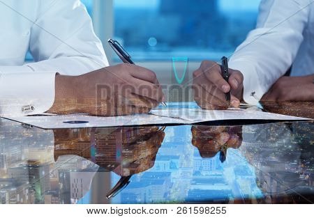 Businessmen Hands Signing Documents On Riyadh Skyline City Scape Background Multi Exposure