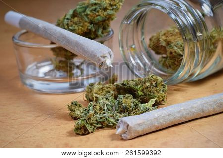 Marijuana Buds, Jar, Money And Joints On The Table