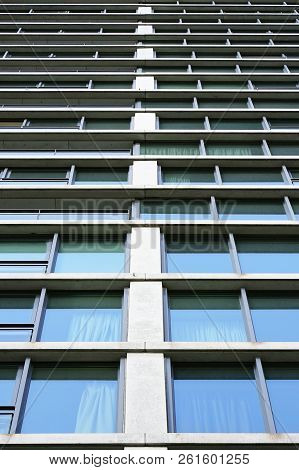 Bottom View Glass Grey Square Windows Of Modern City Business Building Skyscraper. Receding Perspect