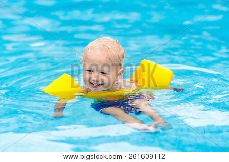 Baby In Swimming Pool. Kids Swim.