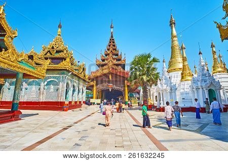 Yangon, Myanmar - February 27, 2018: Pilgrims At The North Gate Of Shwedagon Pagoda, Surrounded By N